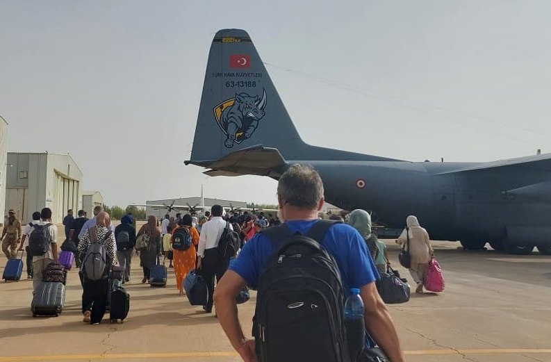 Civilians board a Turkish military aircraft for evacuation amid clashes between army and paramilitary forces, at the Wadi Seidna Air Base in Khartoum, Sudan, April 28, 2023. (AA Photo)