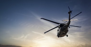 Undated photo of a US Army military helicopter flying against sunset. (Getty Images Photo)
