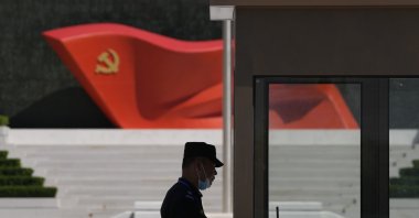A security guard stands near a sculpture of the Chinese Communist Party flag at the Museum of the Communist Party of China, Beijng, China, May 26, 2022. (AP Photo)