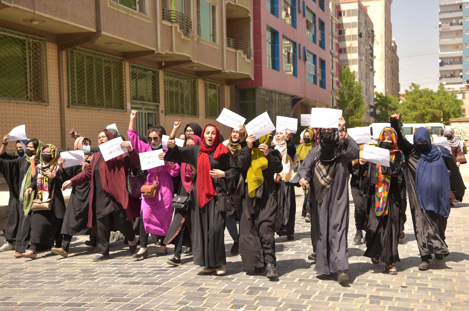 Afghan women hold placards as they march to protest for their rights, in Kabul, Afghanistan, April 29, 2023. (AFP Photo)
