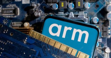 A smartphone with a displayed Arm Ltd logo is placed on a computer motherboard in this illustration taken March 6, 2023. (Reuters Photo)