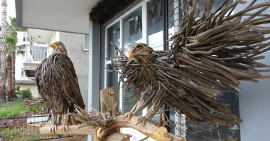 Two eagle figures crafted by Adem Rüzgar from wood charred by forest fires in Antalya, Türkiye, April 30, 2023. (IHA Photo)