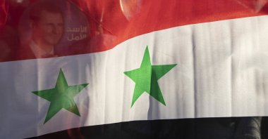 The Syria national flag is seen at the Umayyad Square in the capital Damascus, Syria, May 23, 2021. (AP Photo)
