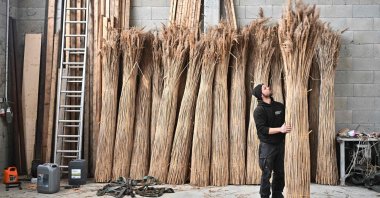 Jacobus van Hoorne checks stacks of reed at his storage at Weiden am See, Austria, March 9, 2023. (AFP Photo)