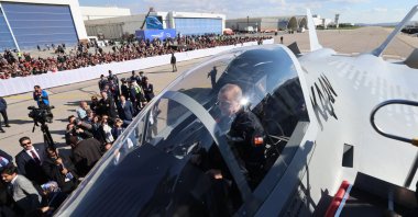 President Recep Tayyip Erdoğan sits inside Türkiye’s domestically developed 5th-generation fighter jet, named &quot;KAAN,&quot; as he attends the &quot;Century of the Future&quot; event at the Turkish Aerospace Industries (TAI) headquarters in the Kahramankazan district of Ankara, Türkiye, May 1, 2023. (AA Photo) 