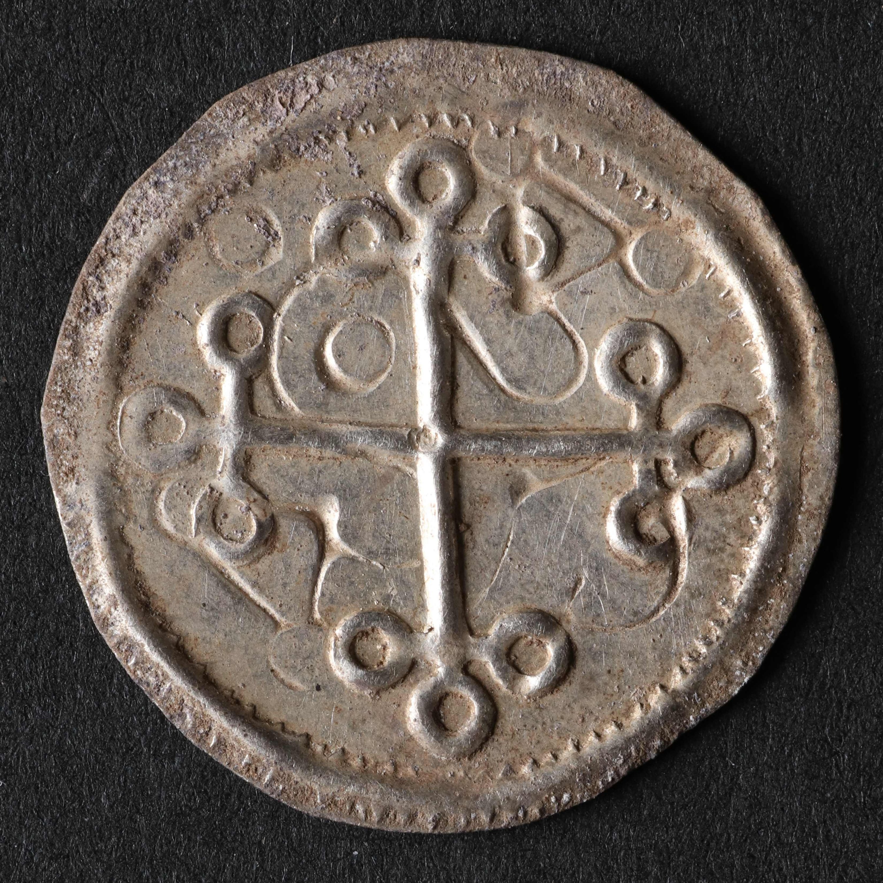 A coin in the Historical Museum of Northern Jutland, a part of a trove believed to be more than 1,000 years old and that was found in autumn 2022 near the Viking fortress site of Fyrkat, near the Danish city of Hobro, April 24, 2023. (AFP Photo)