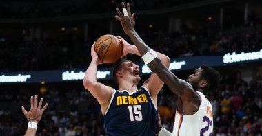 Denver Nuggets center Nikola Jokic C) shoots the ball at Phoenix Suns center Deandre Ayton (R) in the second half during Game 2 of the 2023 NBA playoffs at Ball Arena, Denver, U.S., May 1, 2023. (Reuters Photo)