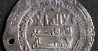 A coin in the Historical Museum of Northern Jutland, a part of a trove believed to be more than 1,000 years old and that was found in autumn 2022 near the Viking fortress site of Fyrkat, near the Danish city of Hobro, April 24, 2023. (AFP Photo)