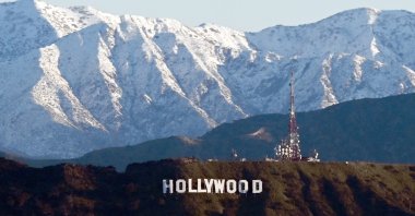 Snow-capped mountains stand on the skyline behind a view of the Hollywood sign following heavy rain from winter storms, as seen from the Kenneth Hahn State Recreation Area, Los Angeles, California, U.S., March 2, 2023. (AFP File Photo)