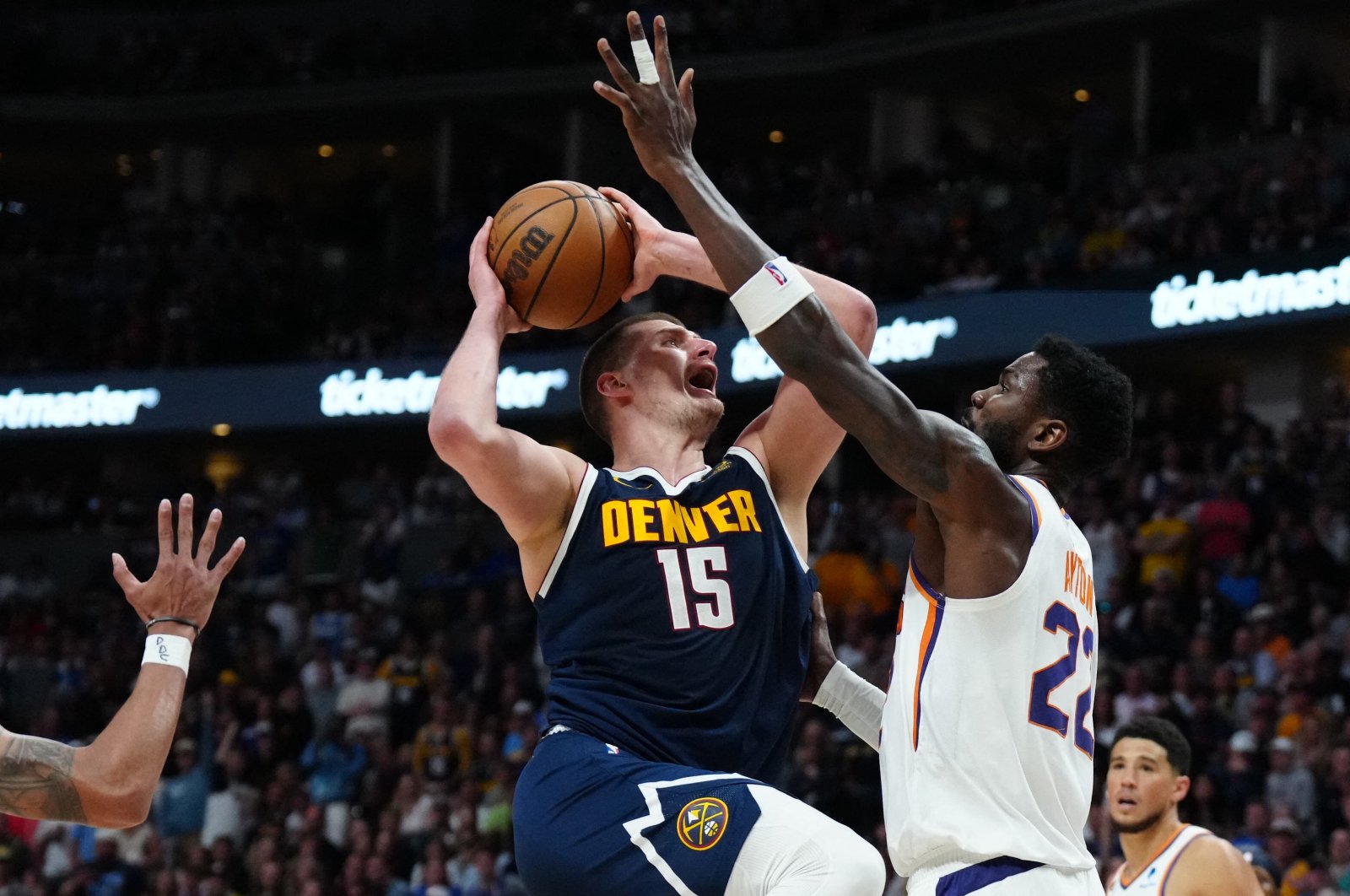 Denver Nuggets center Nikola Jokic C) shoots the ball at Phoenix Suns center Deandre Ayton (R) in the second half during Game 2 of the 2023 NBA playoffs at Ball Arena, Denver, U.S., May 1, 2023. (Reuters Photo)