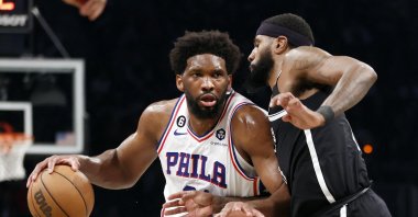 Philadelphia 76ers' Joel Embiid (L) dribbles against Brooklyn Nets' Royce O'Neale during the second half of Game Three of the Eastern Conference First Round Playoffs at Barclays Center, New York, U.S., April 20, 2023. (AFP Photo)
