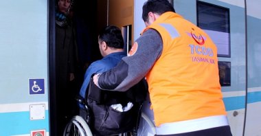 "Orange Desk" staff helping a disabled citizen board a train, Gebze, Türkiye, May 3, 2023. (AA Photo)