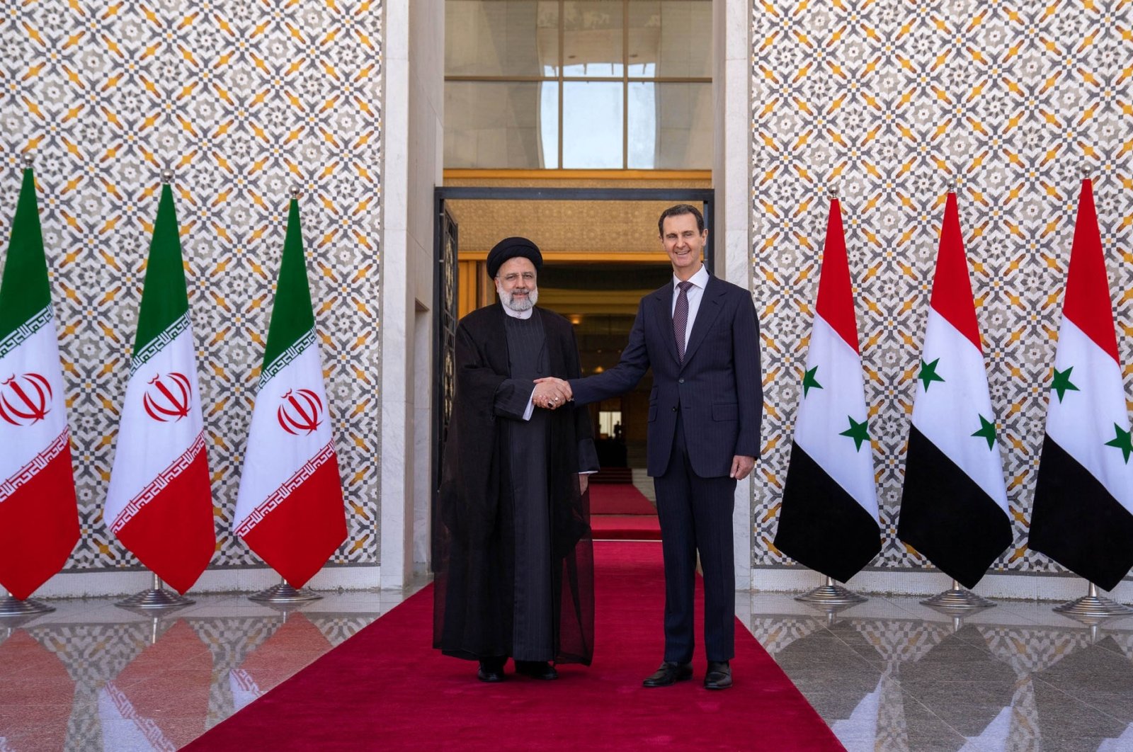 Syria&#039;s Bashar Assad (R) receives his Iranian President Ebrahim Raisi (L) in Damascus, Syria, May 3, 2023.