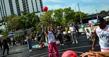 Mercedes' British driver Lewis Hamilton plays with a basketball during a IWC Schaffhausen basketball event ahead of the Miami Grand Prix, Miami, May 3, 2023. (AFP Photo)