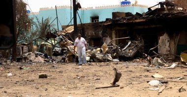 A man walks near damaged buildings at the central market in Khartoum, Sudan, April 27, 2023. (Reuters Photo)