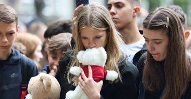 People react as they pay tribute following a school mass shooting in Belgrade, Serbia, May 4, 2023. (Reuters Photo)