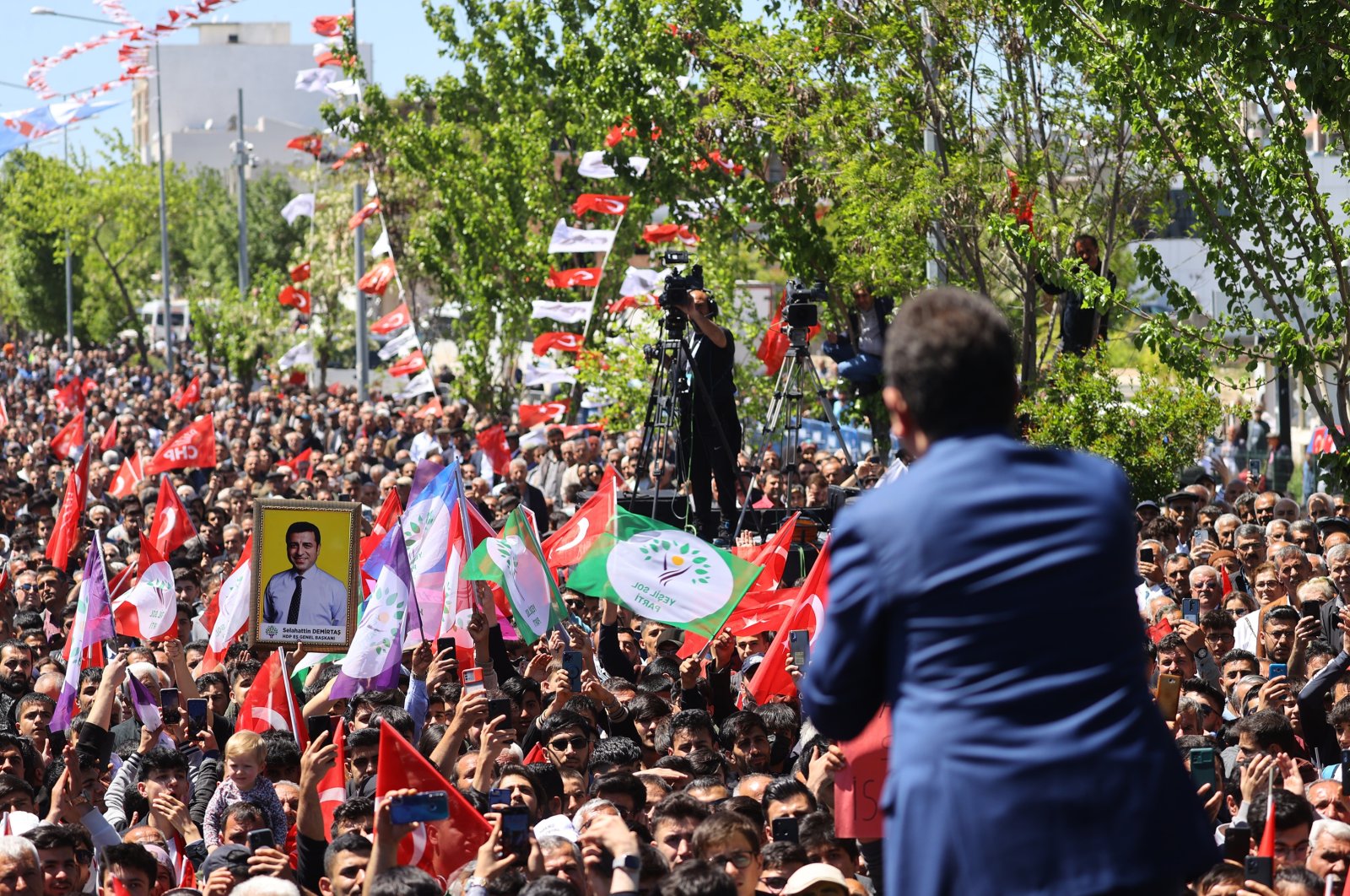 Istanbul Mayor Ekrem Imamoğlu, a member of the opposition bloc, addresses an election rally for Kemal Kılıçdaroğlu as a supporter holds a picture of Selahattin Demirtaş, in Adıyaman, southeastern Türkiye, May 3, 2023. (AA Photo)
