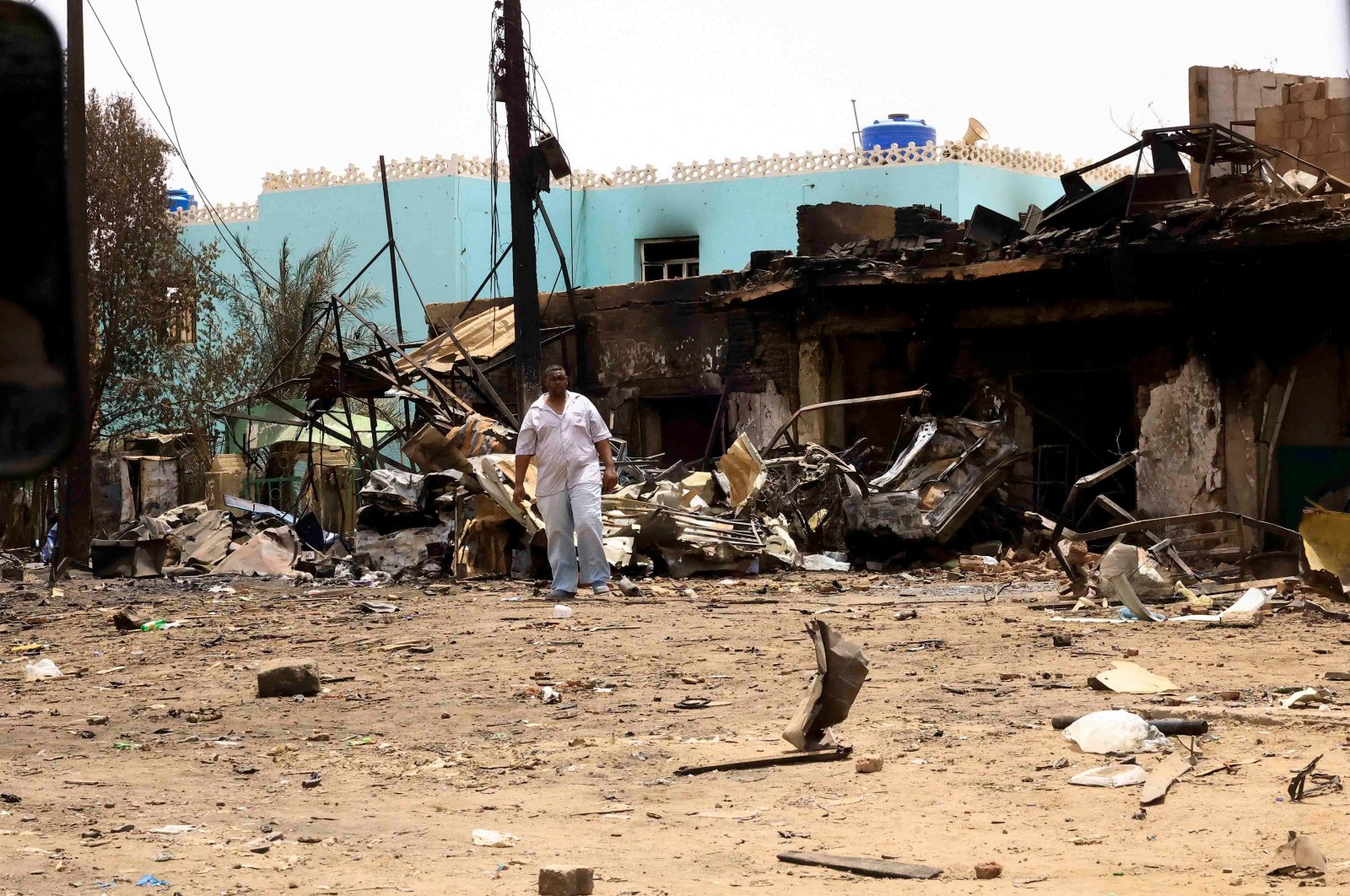 A man walks near damaged buildings at the central market in Khartoum, Sudan, April 27, 2023. (Reuters Photo)