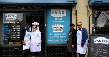epa10592117 Pantry staff members pose for a photo in front of Peckham Pantry in London, Britain, 26 April 2023. People across the UK are using food banks and food Pantry stores more than ever according to food charity Trussel Trust. A record number, some three million food deliveries were given out in 2022. According to Trussel, one in five people using their food banks were in work, highlighting the difficulties families were facing with soaring energy costs and spiralling food inflation.  EPA/ANDY RAIN