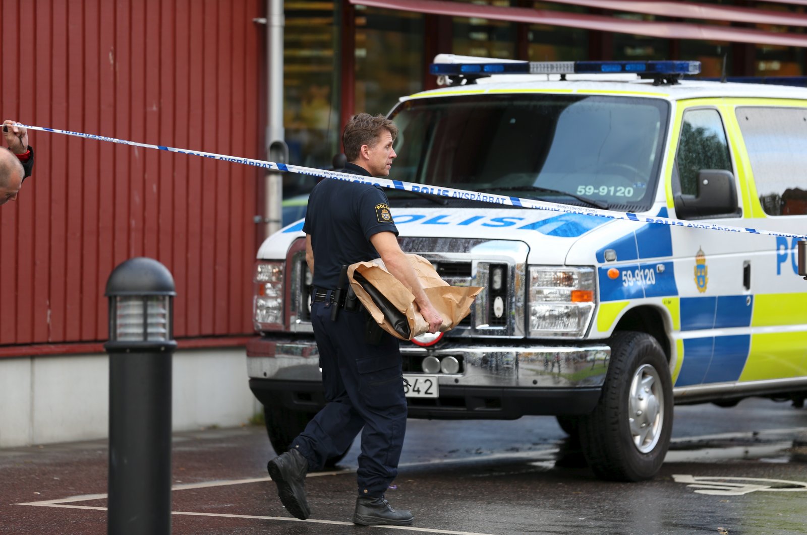A police officer carries an evidence bag as he leaves a crime scene in Trollhattan, western Sweden Oct. 22, 2015. (Reuters File Photo)