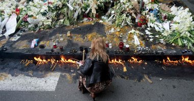 A woman lights candles outside the Vladislav Ribnikar elementary school in the capital Belgrade, Serbia, May 5, 2023. (AFP Photo)