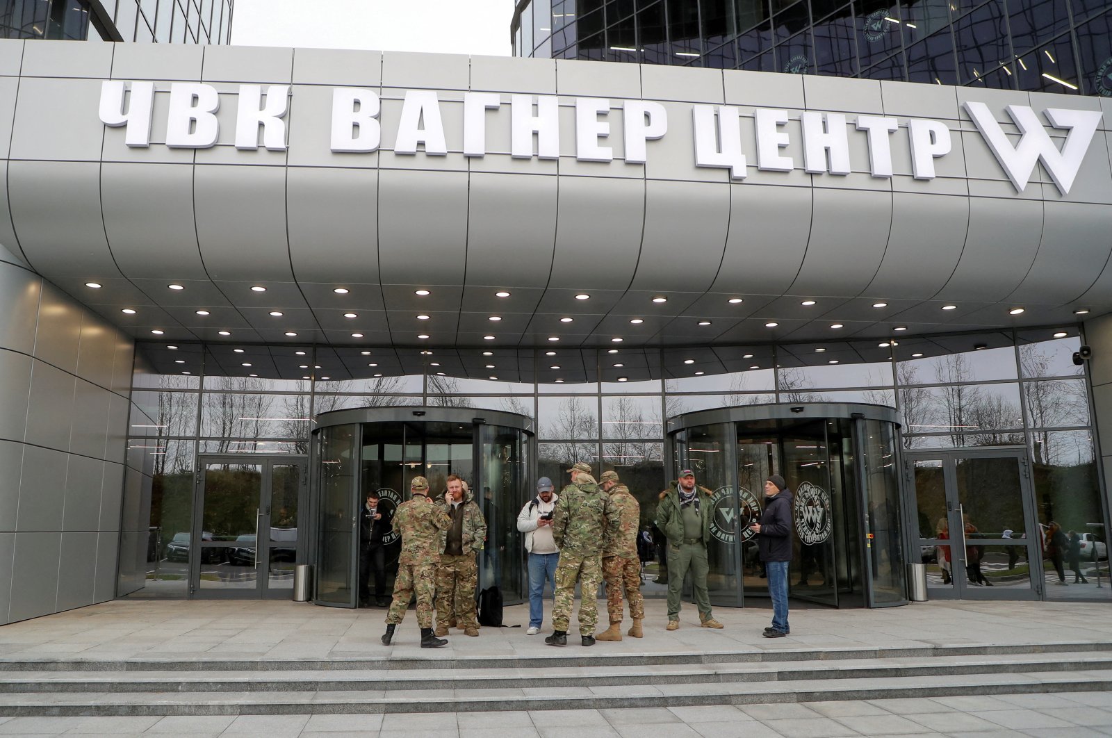 People gather outside PMC Wagner Centre, which is a project implemented by the businessman and founder of the Wagner private military group Yevgeny Prigozhin, during the official opening of the office block in Saint Petersburg, Russia, Nov. 4, 2022. (Reuters File Photo)