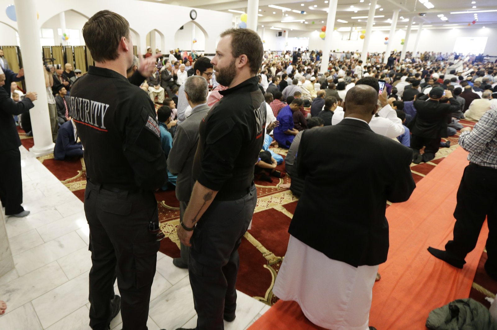 Private security officers stand guard at left during a prayer service at the Muslim Association of Puget Sound Redmond Mosque, Wednesday, July 6, 2016, in Redmond, Wash. (AP File Photo)