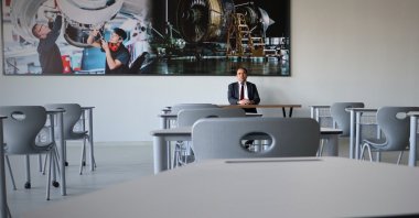Samet Bilecan, the principal of the newly opened Ankara Aerospace Technologies Vocational and Technical Anatolian High School, is photographed sitting in one of the classrooms, Ankara, Türkiye, May 7, 2023. (DHA Photo)
