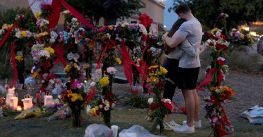People hug as they visit a memorial to the victims of a mass shooting in Allen, Texas, U.S., May 7, 2023. (AFP Photo)