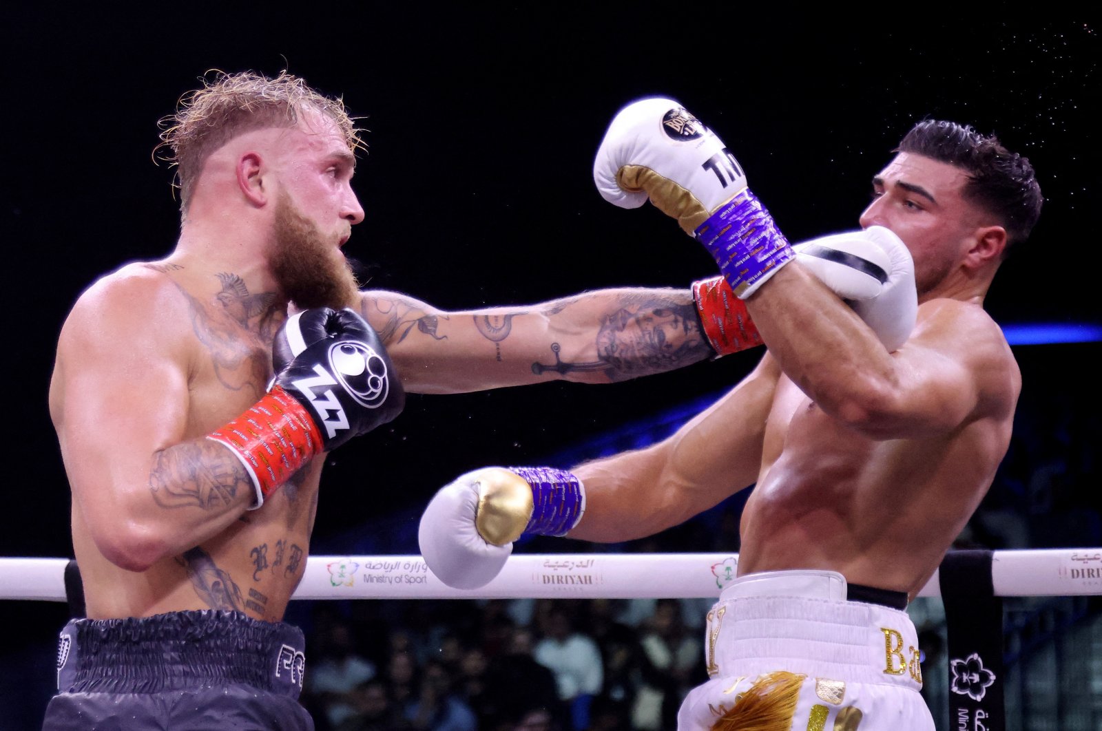 Jake Paul (R) punches Tommy Fury at the Diriyah Arena, Diriyah, Riyadh, Saudi Arabia, Feb. 27, 2023. (Reuters Photo) 