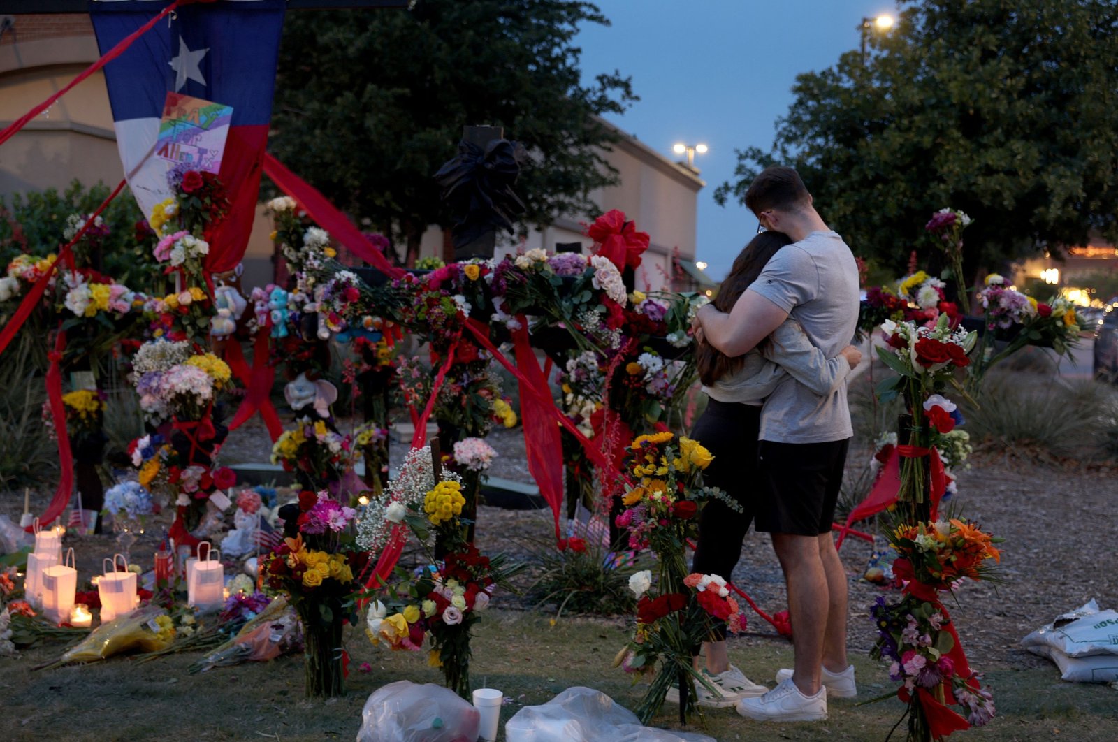 People hug as they visit a memorial to the victims of a mass shooting in Allen, Texas, U.S., May 7, 2023. (AFP Photo)