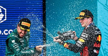 Red Bull Racing's Dutch driver Max Verstappen (R), who placed first, and Aston Martin's Spanish driver Fernando Alonso (L), who placed third, celebrate on the podium after the 2023 Miami Formula One Grand Prix at the Miami International Autodrome, Miami, US., May 7, 2023. (AFP Photo)