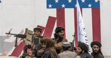 Taliban fighters celebrate one year since they seized the Afghan capital, Kabul, in front of the U.S. Embassy in Kabul, Afghanistan, Aug. 15, 2022. (AP Photo)