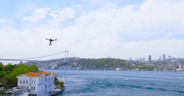 A Yurtiçi Kargo cargo drone flies over the Bosporus in Istanbul, Türkiye, May 9, 2023. (IHA Photo)