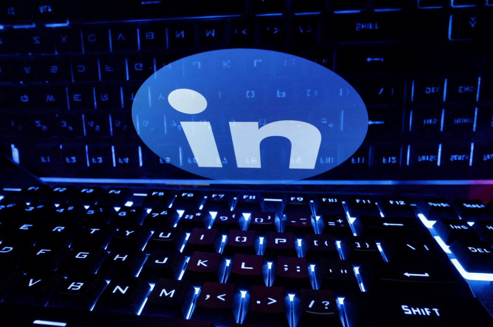 A keyboard is placed in front of a displayed LinkedIn logo in this illustration on taken Feb. 21, 2023. (Reuters Photo)