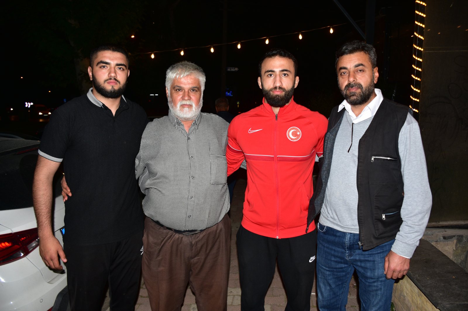 Turkish wrestler Burhan Akbudak (2nd R), who won the gold medal at the European Wrestling Championship held in Croatia, stands with the family of his wrestler friend who lost his life in the earthquake, Kahramanmaraş, Türkiye, May 8, 2023. (AA Photo)