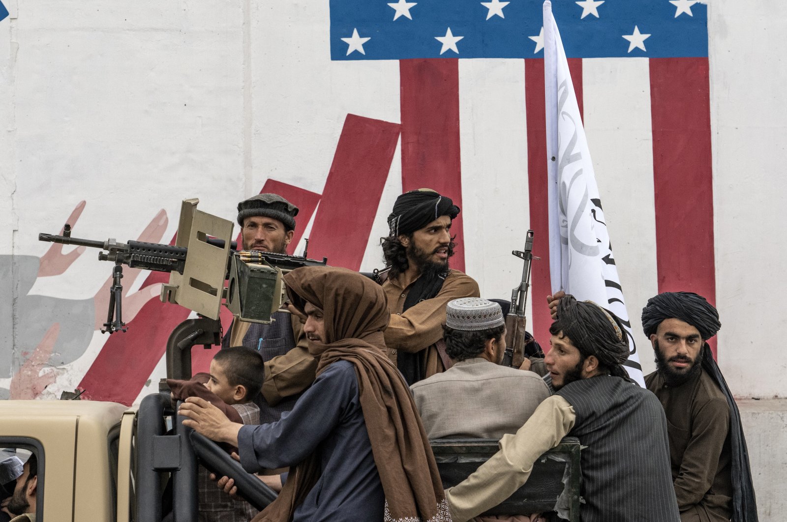 Taliban fighters celebrate one year since they seized the Afghan capital, Kabul, in front of the U.S. Embassy in Kabul, Afghanistan, Aug. 15, 2022. (AP Photo)