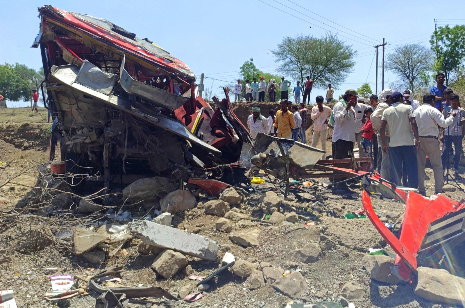 Onlookers gather at the site of a bus accident in Khargone district of Madhya Pradesh, India, May 9, 2023. (AFP Photo)