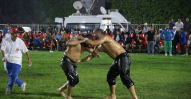 Eventual champion Ali Gürbüz (R) in action with Ali Yanatma during the Marmaris oil wrestling final match, Marmaris, Türkiye, May 9, 2023. (IHA Photo)