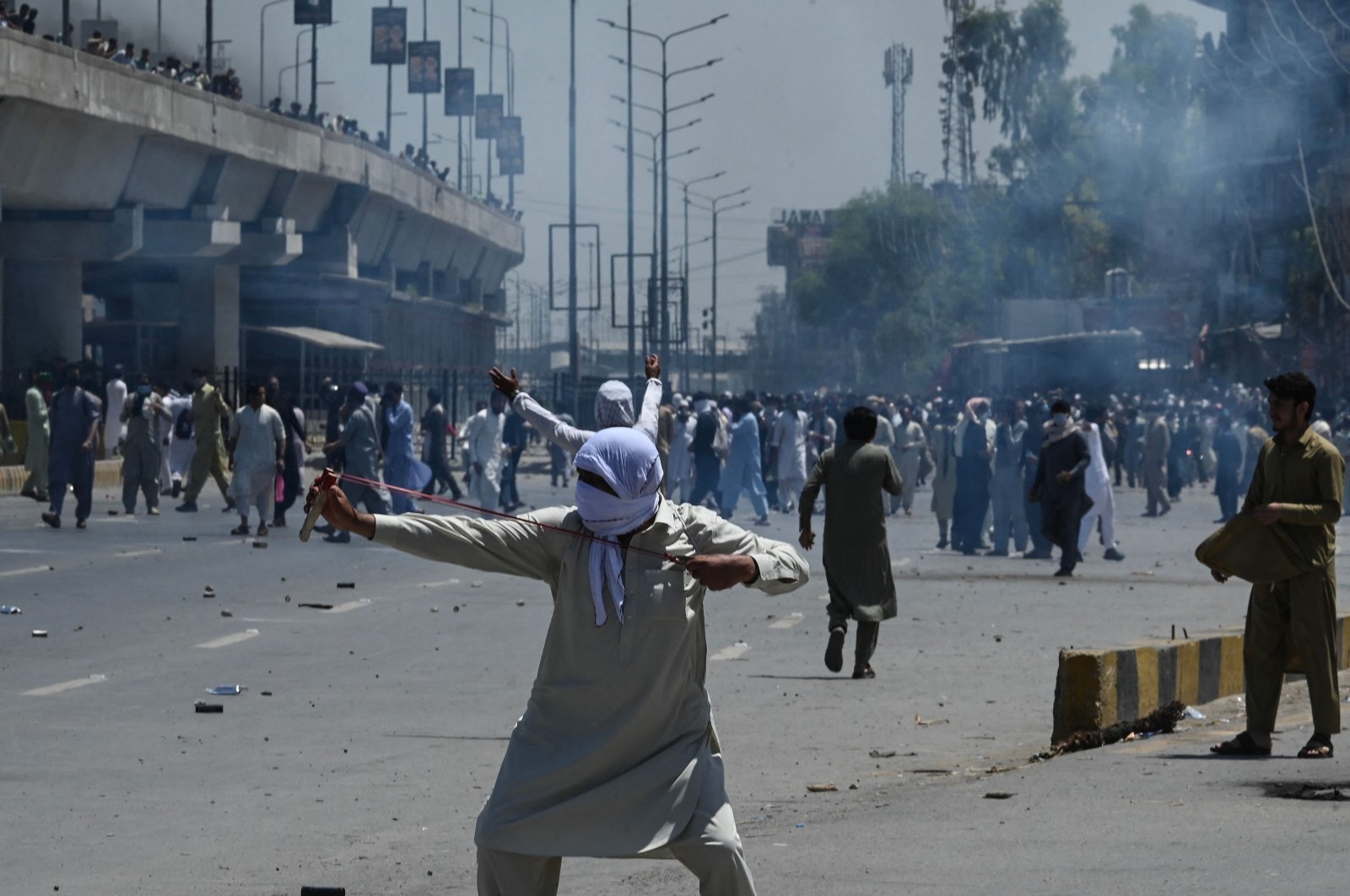 Pakistan Tehreek-e-Insaf (PTI) party activists and supporters of former Prime Minister Imran Khan clash with police in Peshawar, Pakistan, May 10, 2023. (AFP Photo)