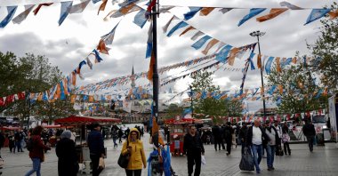 People walk at Eminönü Square decorated by political party flags ahead of the May 14 presidential and parliamentary elections, in Istanbul, Türkiye, May 10, 2023. (Reuters Photo)