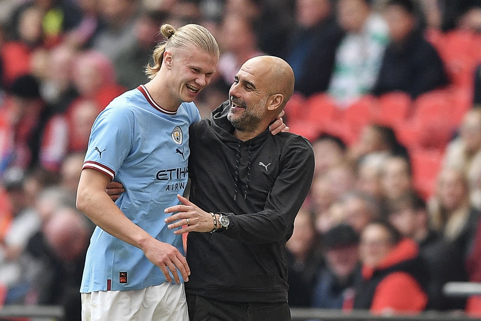 Manchester City coach Pep Guardiola (L) and Erling Haaland during FA Cup semifinal match against Sheffield United at Wembley Stadium, London, U.K., April 22, 2023. (Getty Images Photo)