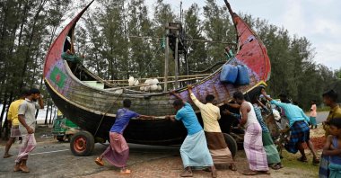 Fishermen shift a boat to a safer place ahead of Cyclone Mocha landfall, Teknaf, Bangladesh, May 13, 2023. (AFP Photo)