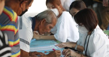 Thai voters register to cast ballots during the general election at a polling station, Bangkok, Thailand, 14 May 2023. (EPA Photo)