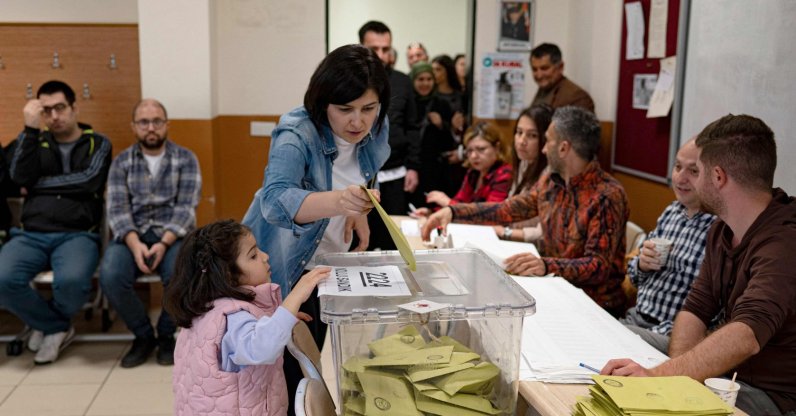A voter casts her ballot for presidential and parliamentary elections at a polling station in a government school in Istanbul, Türkiye, May 14, 2023. (AFP Photo)
