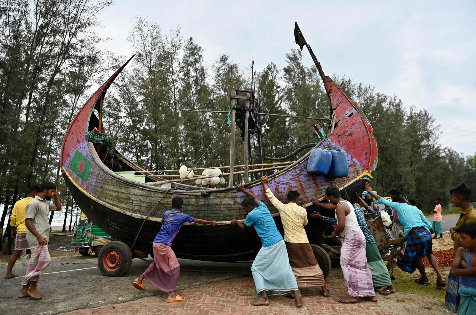 Fishermen shift a boat to a safer place ahead of Cyclone Mocha landfall, Teknaf, Bangladesh, May 13, 2023. (AFP Photo)