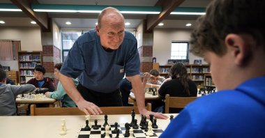 Custodian and chess coach David Bishop challenges 6th-grader Owen Isenhour during after-school practice, Hampden, Maine, U.S., April 25, 2023. (AP Photo)