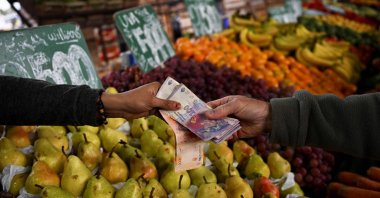 A man buys fruits and vegetables at the Central Market in Buenos Aires, Argentina, May 12, 2023. (AFP Photo)