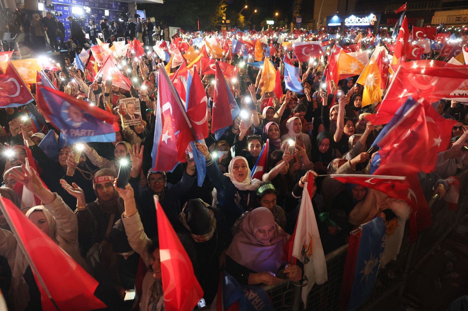 Supporters of President Recep Tayyip Erdoğan wave flags outside the AK Party headquarters, in the capital Ankara, Türkiye, May 15, 2023. (AFP Photo)