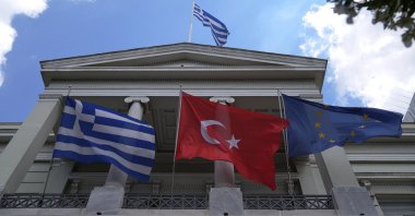 Greek, Turkish and European Union flags wave on the foreign ministry house before a meeting of Greek Foreign Minister Nikos Dendias and his Turkish counterpart Mevlüt Çavuşoğlu in Athens, Monday, May 31, 2021. (AP File Photo)